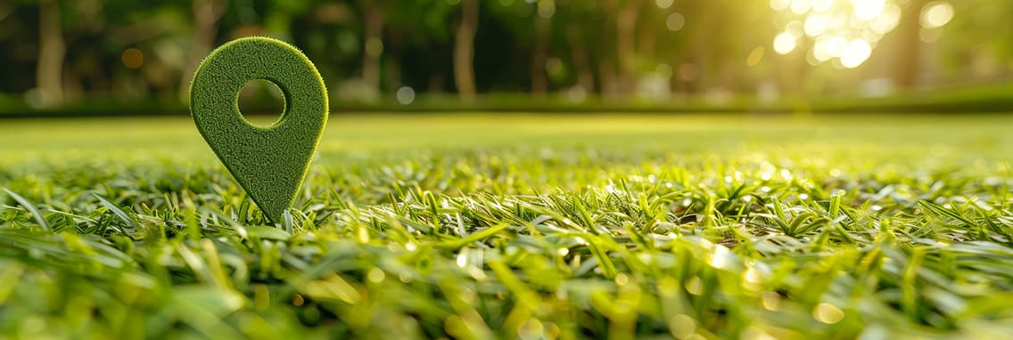Panoramic view of location pin in sunlit grass field